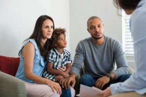 A mother, father, and child meeting with a DIPG Counselor