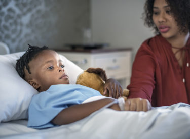 Worried mother consoling thoughtful ill son