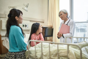 Female doctor meeting with mother and child