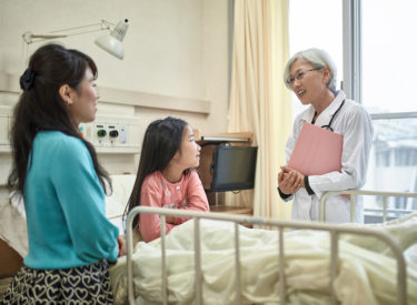 Female doctor meeting with mother and child