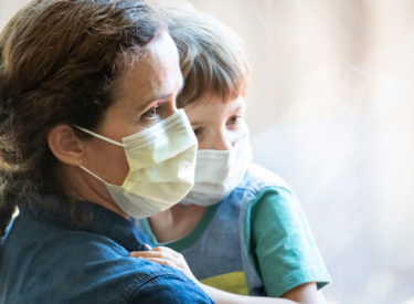 Women and Son posing with facemasks