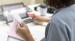 Medical doctor working on patient paperwork