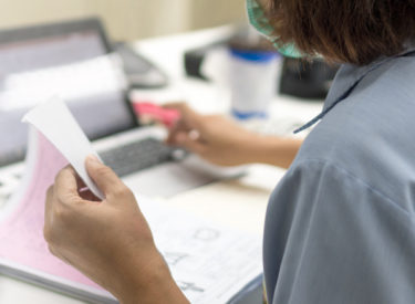 Medical doctor working on patient paperwork