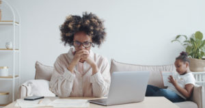 Stressed young woman doing paperwork at home