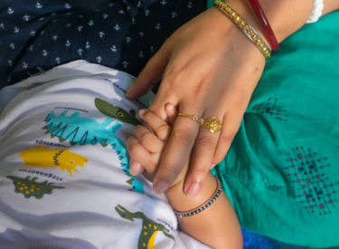 mother's hand holds the hand of a newborn. little baby fingers. love, family values, family medicine, healthcare, maternity hospital.