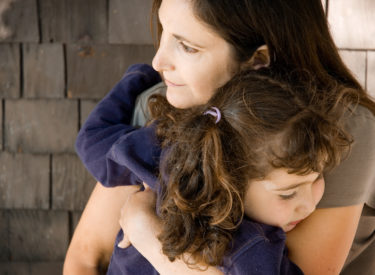 Mother holding daughter