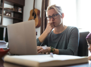 A mother reviewing DIPG support resources on her computer