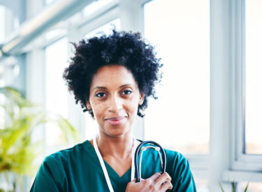 A happy female DIPG Nurse Navigator ready to provide support